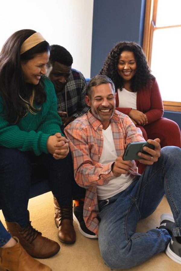 Family members smiling and enjoying a casual moment together, highlighting the importance of emotional well-being.