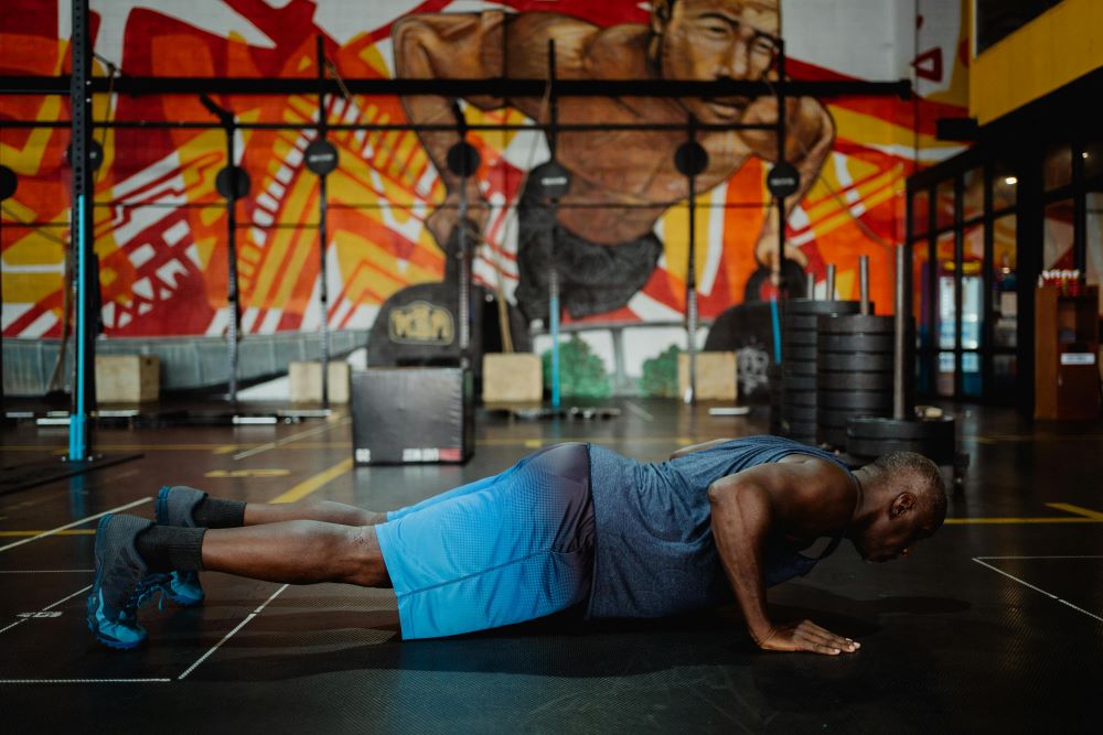 Man doing a push-up with arms extended and body in a straight line.